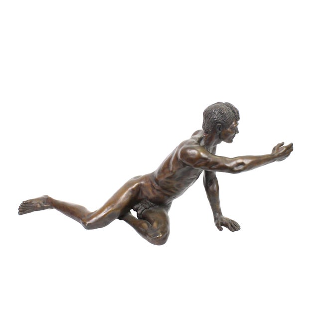 Massive and eye-catching bronze sculpture by Donald Claude Noel. Features a nude man, sprawling across the floor and...