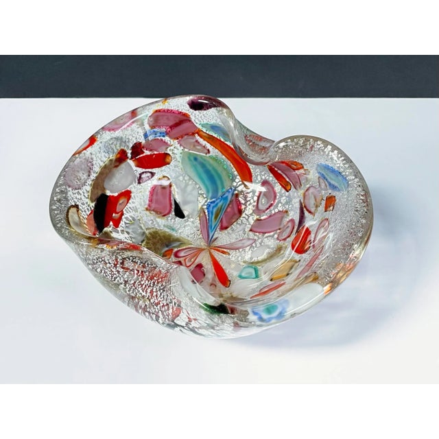 Vintage Murano art glass bowl featuring a rainbow of colors and shimmery silver leaf encased in clear glass. Remnant of a...