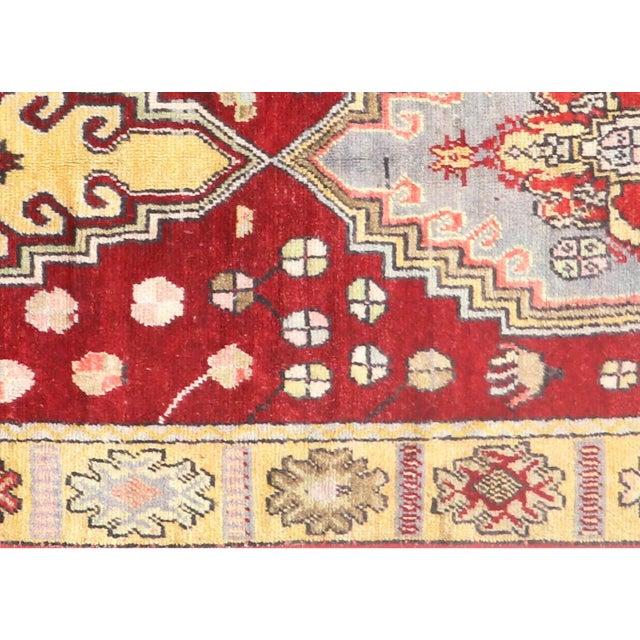 Handwoven vintage Turkish Oushak runner measuring 3'6" x 10'7". Crafted with wool on wool foundation in Western Turkey's...