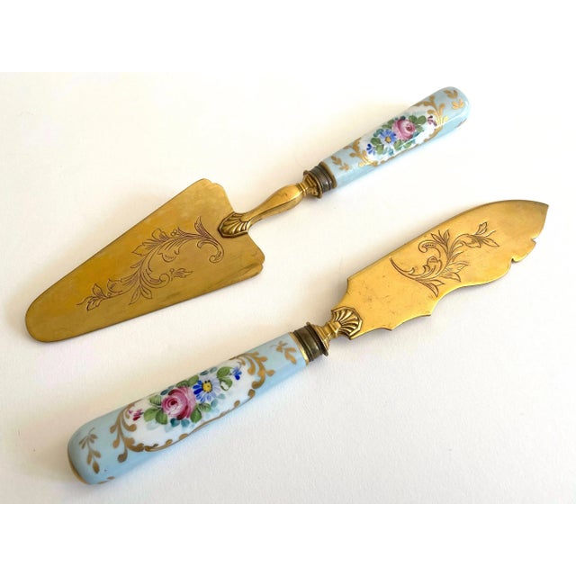 This two piece set of rare antique early 1900's Neoclassical hand painted floral gilded porcelain brass fish serving...