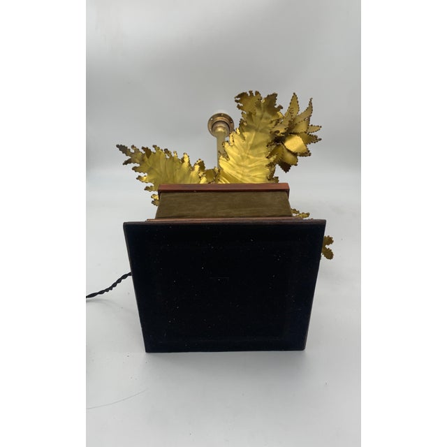 A sculptural and decorative table lamp attributed to Barbi, made in Italy, featuring a solid wooden base with contoured...