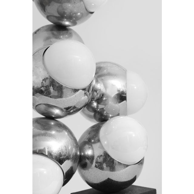 Space Age table lamp designed by Robert Sonneman. A sculptural cluster of chrome spheres set on a weighted rectangular...