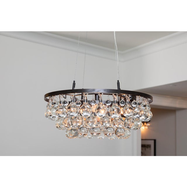 The Ochre Pear Chandelier is a sculptural ceiling fixture known for its elegant, modern form. Dozens of hand-blown glass...