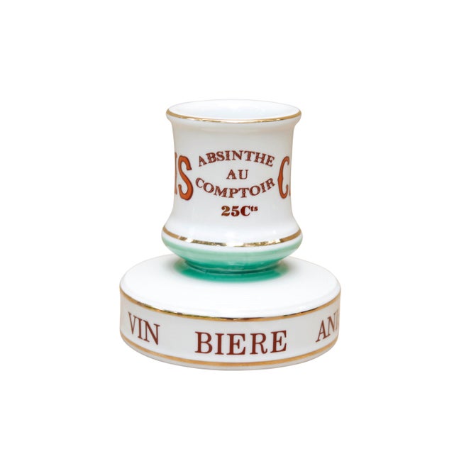 A traditional French, Parisian cafe ceramic match striker. Writing around bottom edge reads 'Vin, Biere, Anisette, Rhum,...