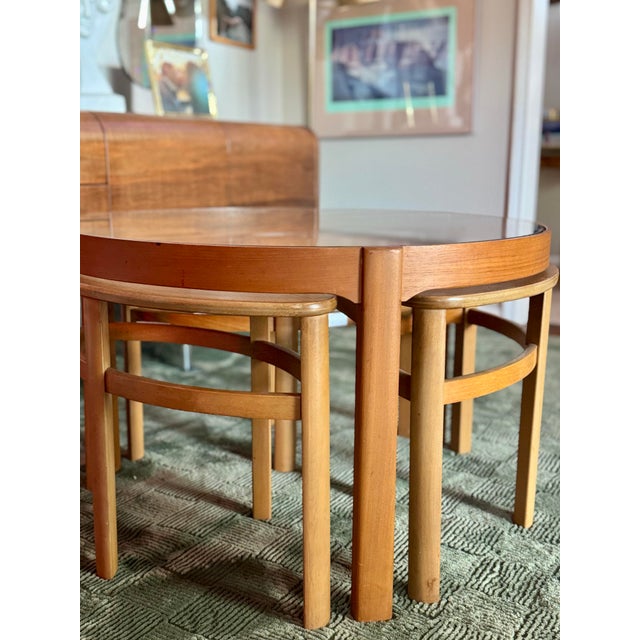 A truly functional Astro teak and glass coffee table by Nathan Furniture, circa 1960s. Made from solid teak with its...