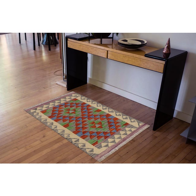 Elevate the elegance of your home with this stunning hand-woven tribal Kilim wool rug. Meticulously crafted on a loom by...