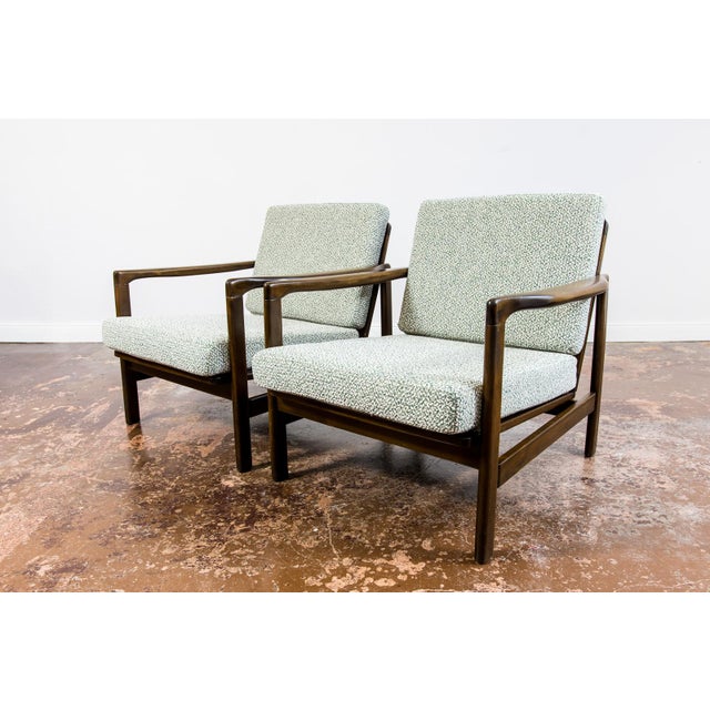 A pair of club chairs "type B7522," designed by Zenon Bączyk and produced in Poland in the 1960s, exemplifies the...