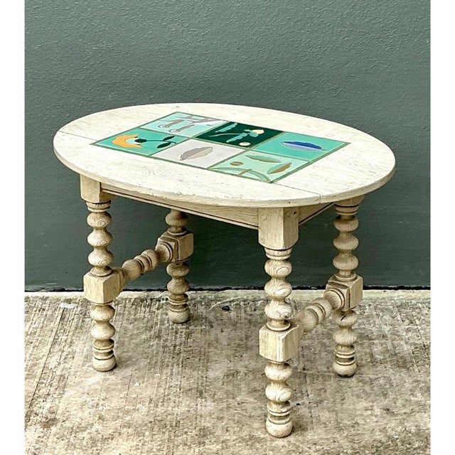 This vintage occasional table pairs charming rustic craftsmanship with an artistic ceramic tile inset, centered within a...
