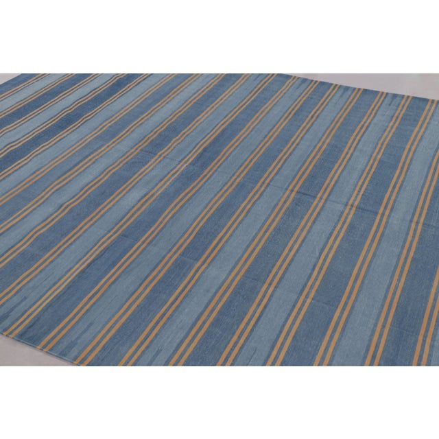 This 9x12 Dhurrie rug features horizontal stripes in slate blue and ochre, representing an exciting contemporary flatweave...