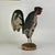 An original hand carved vintage primitive Folk Art rooster. He's a beastly and glorious thing where we can almost hear his...