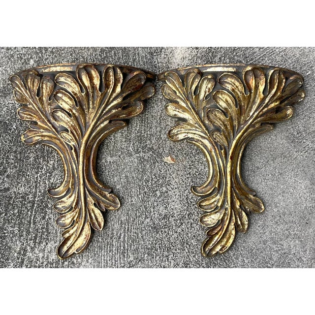 A fabulous pair of vintage Regency wall brackets. Chic hand carved laurels with a silvery gold finish. Acquired from a...