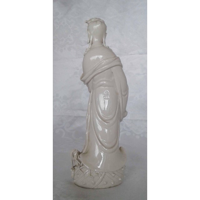 Exude elegance and tranquility in your home with this finely detailed Dehua Blanc de Chine porcelain statue depicting...