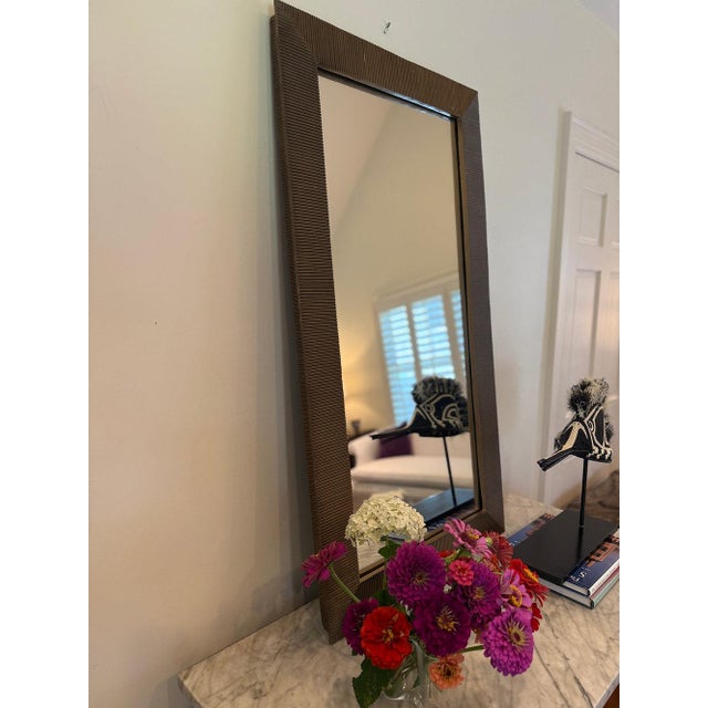 A pair of substantial, contemporary rib-framed mirrors of cast metal. Very heavy. These sleek pieces complement any type...