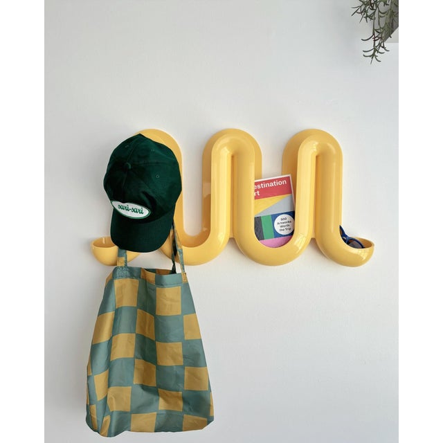 Transform your home’s entrance into a fun and multi-functional space with the whimsical wave-like Heller® Swell™ wall-...