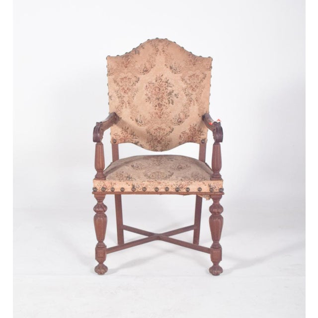 Armchair with upholstered back and seats. In carved wood, of Renaissance inspiration, with a high, cut-out backrest,...