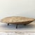 Trent Kendrick VESSEL - MESA stoneware with glaze A flat form raised on three legs, hovering just above the surface it...
