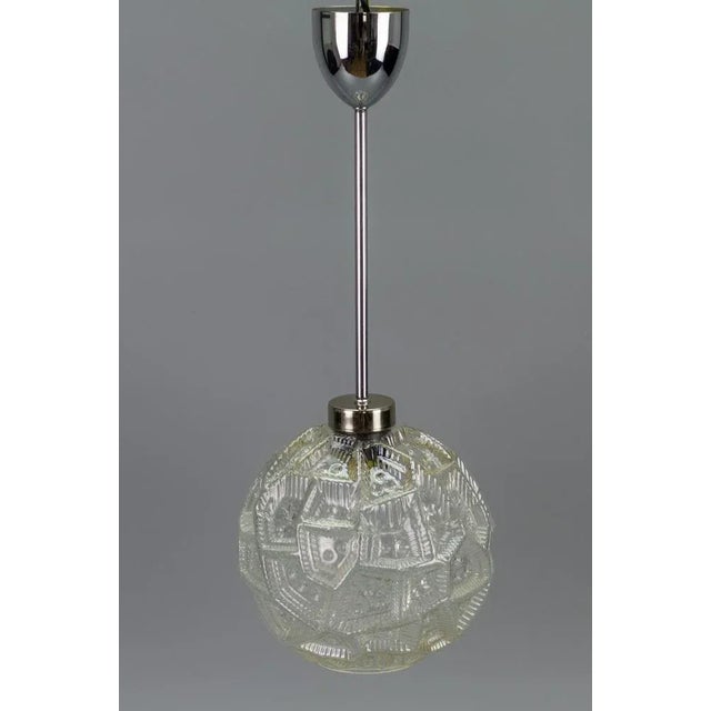 - Mid-Century Modern pendant light with clear glass globe lampshade and chrome fitting. - Light reflects and refracts...