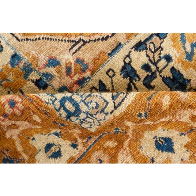 An early 20th century Bidjar rug, the abrashed golden brown field with an overall design of palmettes, feathery leaves,...