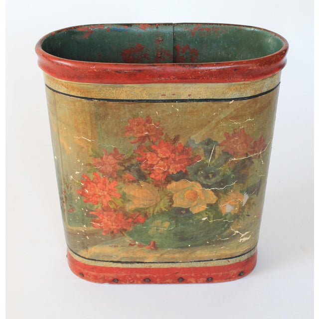 Antique floral leather wrapped wastebasket with wood bottom. No makers mark. Overall age wear.