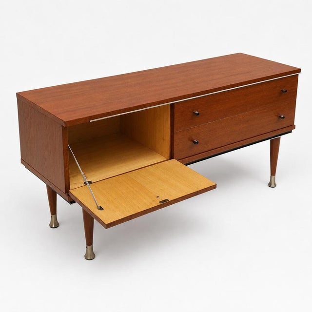 Vintage Low Teak Sideboard 1960s – Mid-Century Design. This authentic vintage sideboard from the 1960s is crafted from...