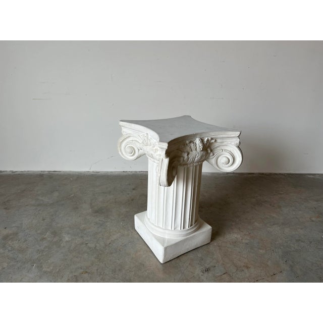 A substantial Vintage white plaster Iconic column shape side table / pedestal in the Neoclassical design style, circa...