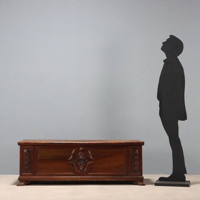 Walnut chest. Front with central floral carving and side scroll carving. Bracketed legs. Modifications. Italy, late 18th...