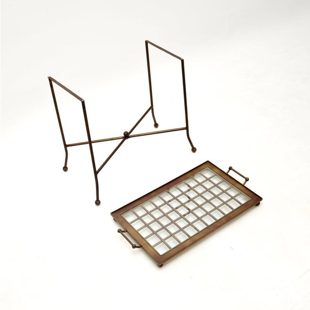 A smart and stylish vintage patinated brass and glass tray top side table, made in France and dating from around the...