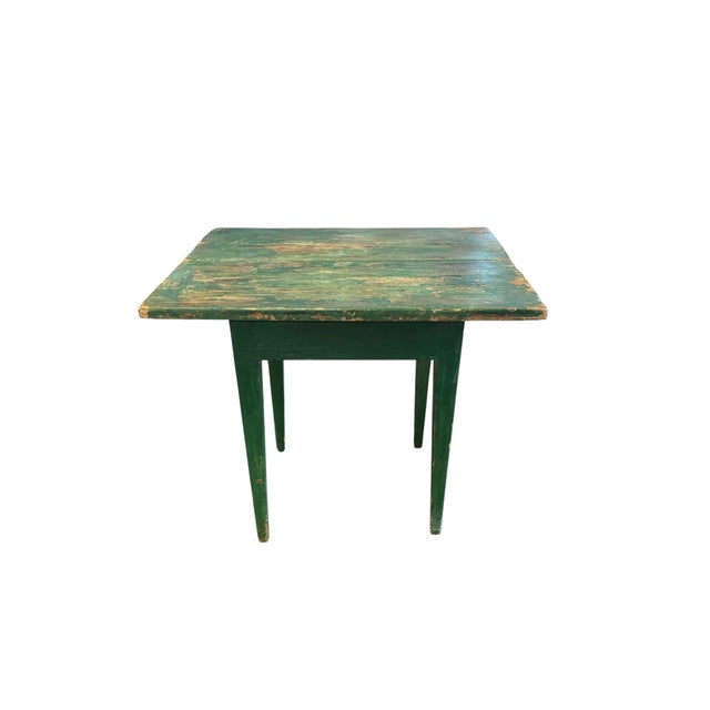 A charming antique primitive table featuring a beautifully worn original green painted surface with substantial age and...