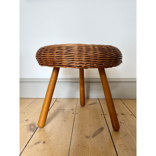 Vintage wicker tripod stool / side table in the manner of Tony Paul, 1960s Woven wicker circular seat on beech legs. The...