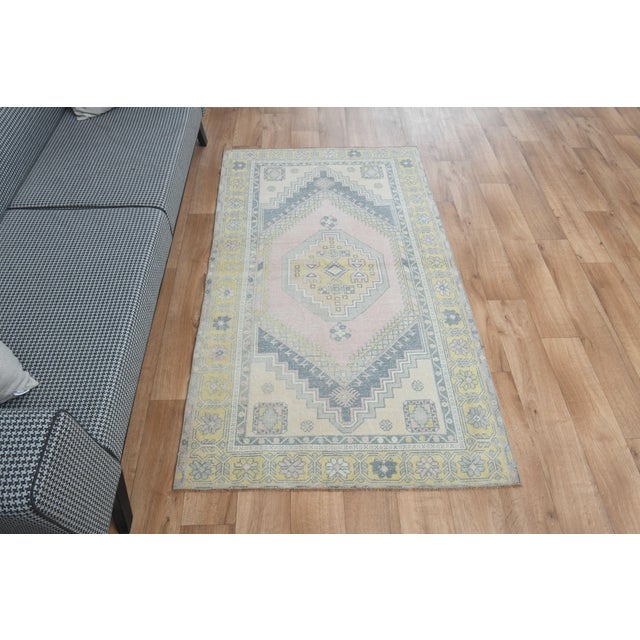This vintage hand-knotted area rug is a semi-antique vintage area rug. The '70s Eastern region of Anatolian's unique rug...