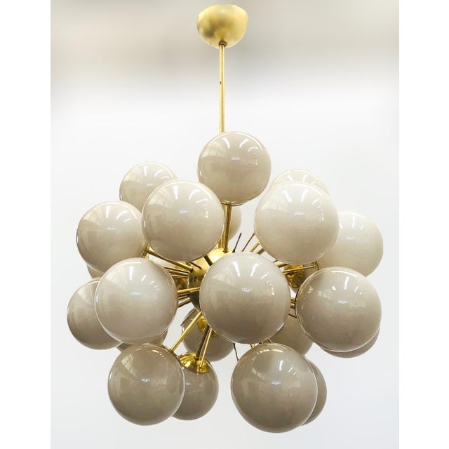 Italian sputnik chandelier with 24 Murano glass globes mounted on brass frame in unlacquered natural brass finish / Made...