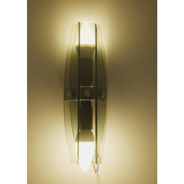 Pair of sculptural Italian glass wall sconces with faceted smoked grey fume glass. An elegant pair of vintage Italian...