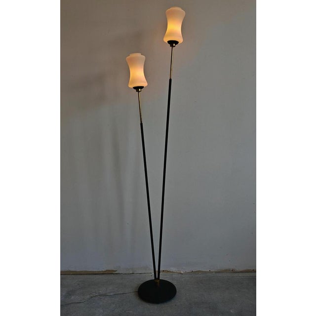 In this listing you will find a sleek Mid Century Modern double floor lamp done in brass, with sculptural milk glass...