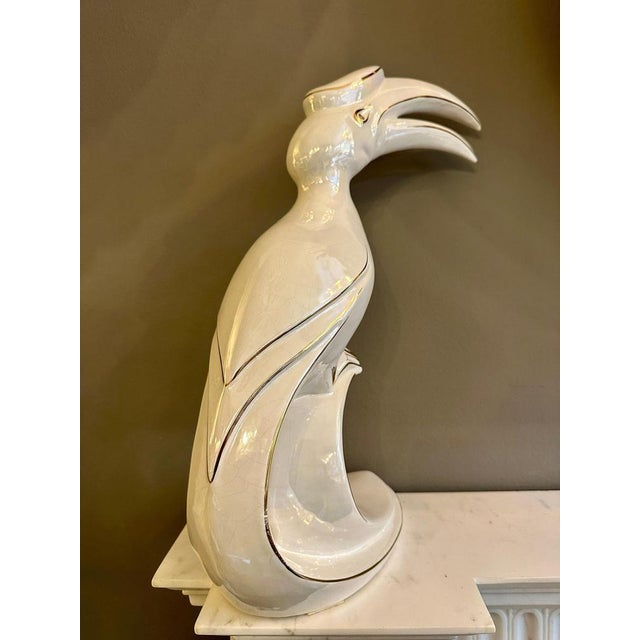 A tall porcelain and 24k gold gilt tropical bird by Italian company Ahura. Signed at base, good size and form. Condition...