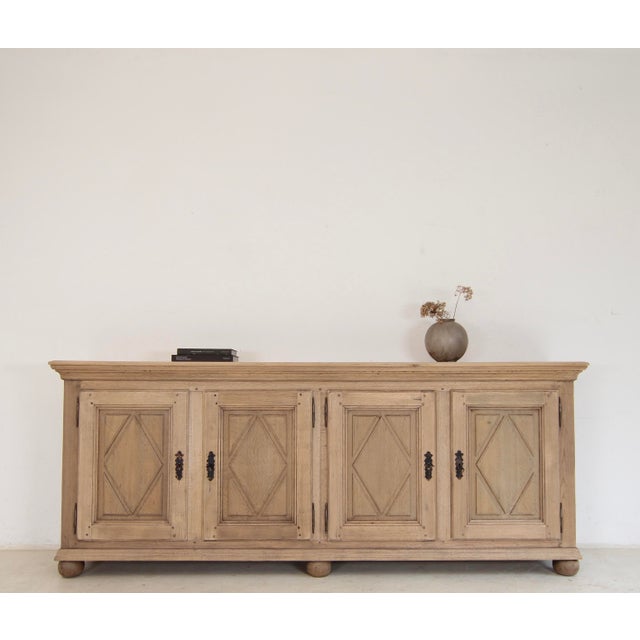 Large sideboard from the first half of the 20th century. Crafted from solid oak. The oak body, featuring panelled sides,...
