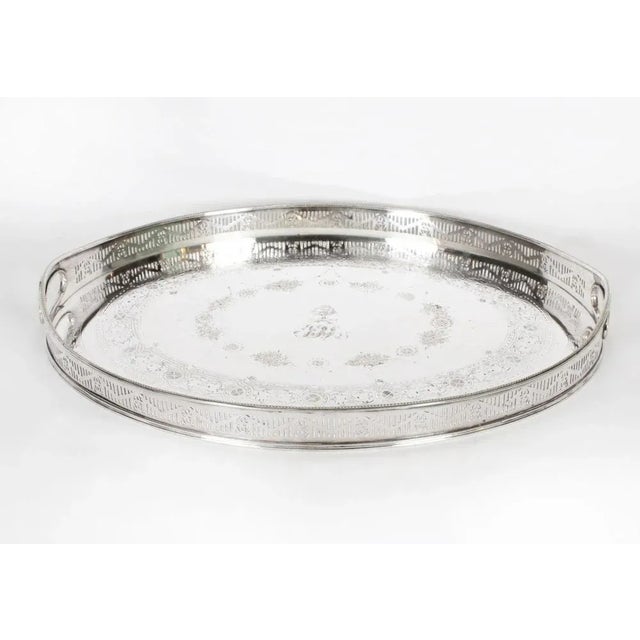 This is a large beautiful antique English Victorian Neo- Classical oval silver-plated twin handled gallery tray, circa...