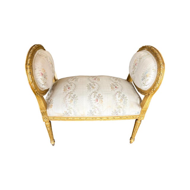 This small bench has a beautiful giltwood frame. Depicted by fluted legs and an oval shaped back. It is upholstered in a...