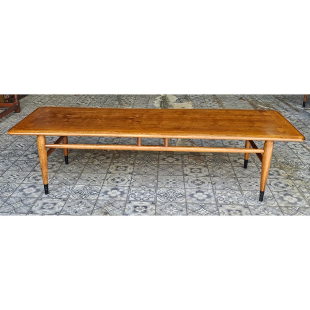 A 1961 Lane Acclaim Dovetail Walnut Coffee Table. Measures 56" in width, 19" in depth and 44" in height.