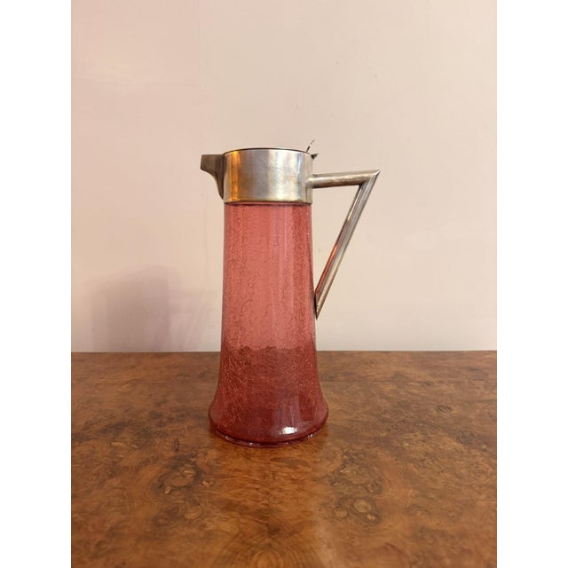 Unusual large antique Edwardian cranberry glass water jug, having a quality large antique Edwardian cranberry glass water...