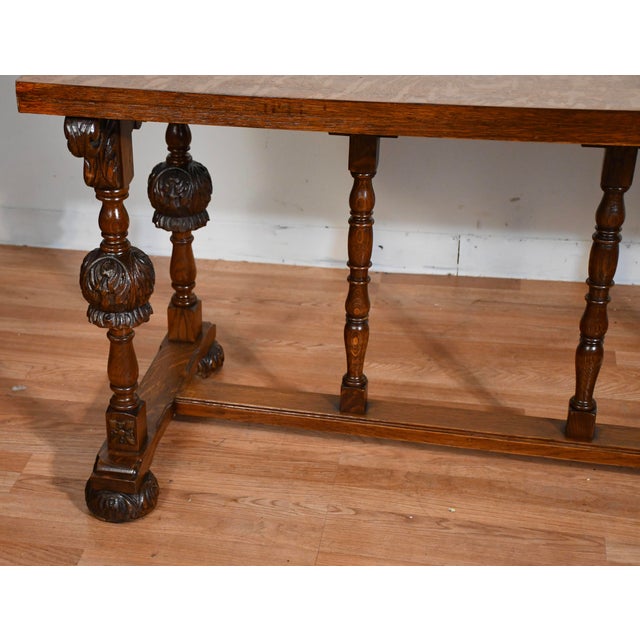 Description: Exceptional antique tiger oak trestle table crafted from solid quarter sawn oak, (circa 1890–1910). This...