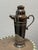Design Plus Gallery presents a Vintage Art Déco Style Silver-Toned Cocktail Shaker. The shaker has a flared foot,...