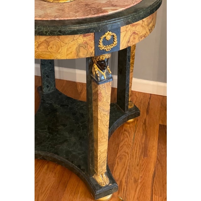 Elevate your space with this striking Neoclassical Empire-style accent table, a piece that effortlessly blends timeless...