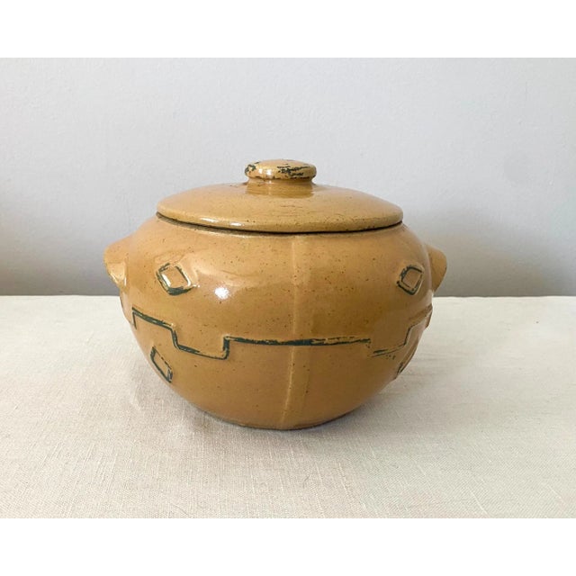 Vintage earthenware bean pot or stoneware crock, dating to about the 1940s. The pot has a Southwestern or Western design,...