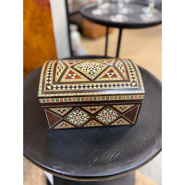 This is a handmade vintage mosaic wooden jewelry box with mother-of-pearl inlay. It features intricate geometric patterns...