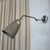 This industrial, mid-century, articulating task lamp circa the 1950s features a rugged, adjustable steel extension arm...