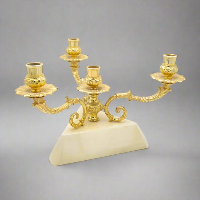 An Aldo Tura Modernist three arm candelabra. Patinated brass arms with wooden base covered in laquered parchment. The...