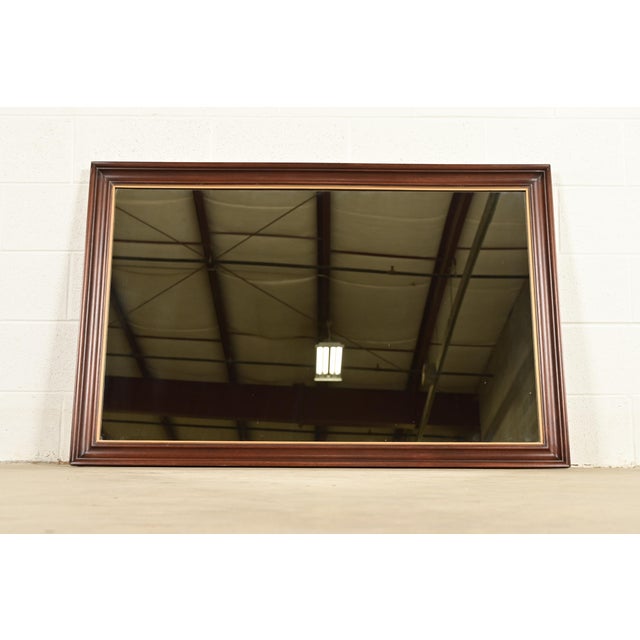 A gorgeous Federal style solid mahogany and gold gilt framed wall mirror By Henkel Harris USA, 1972 Measures: 52.5"W x 2"D...