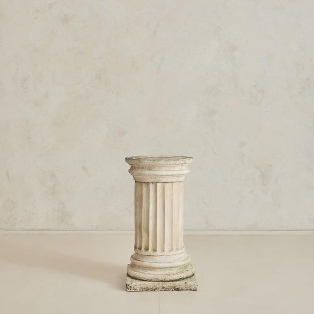 A French stone pedestal from the 1960s, drawing on classical column forms. Carved from solid stone, the form rises from a...