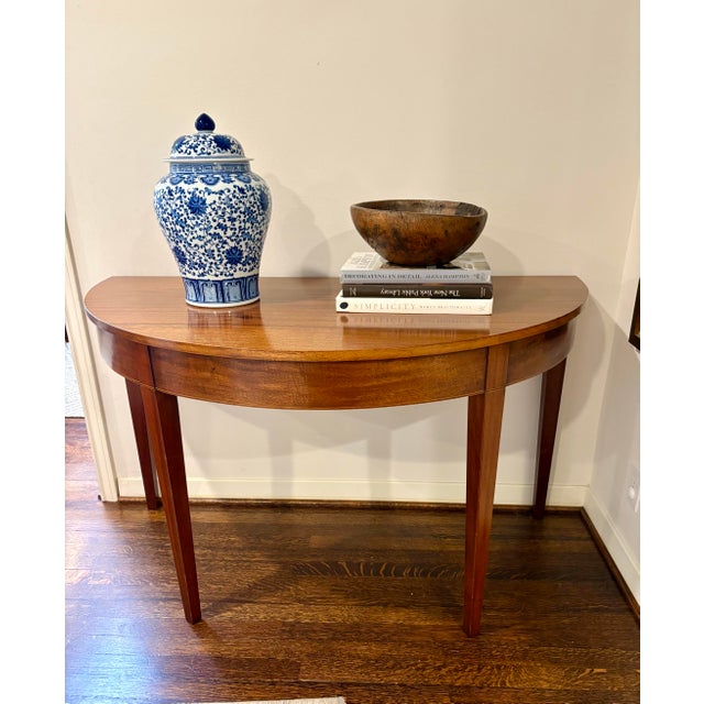 Stunning pair of Federal Style Mahogany Demilune Tables, early 20th century. The tables may be joined to create a large...