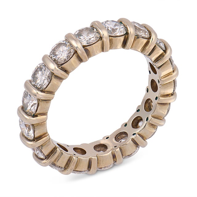 A timeless and elegant vintage eternity band, this beautiful ring features seventeen round brilliant cut diamonds totaling...